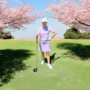 Ladies Merino Golf Set - Lilac worn by woman standing on golf course with cherry blossoms in background